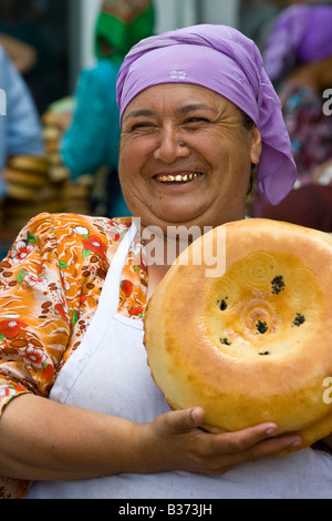 Uzbek Woman Selling Bread in the Siab Market in Samarkand Uzbekistan Stock Photo