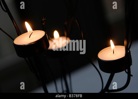 3 tealights burning at a wedding reception.  They were part of a table decoration in a metal holder Stock Photo