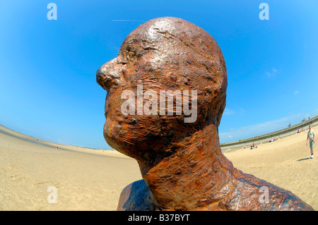 another place anthony gormley crosby beach liverpool merseyside cast-iron life-size figure art staring horizon fisheye lens Stock Photo