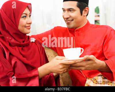 Malay couple chatting and having coffee Stock Photo