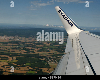 Ryanair Boeing 737-800 wing showing wing tip flying over land Stock Photo