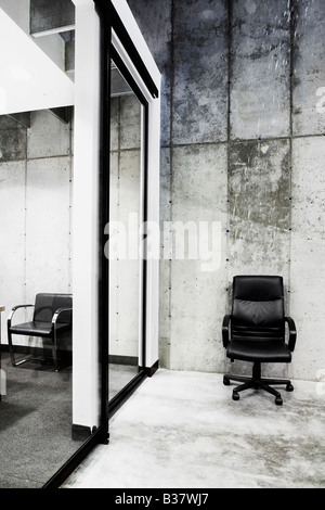 Detail of a lone leather office chair in modern office building Stock Photo