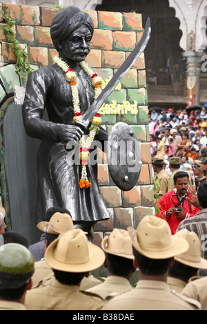 Police officers watch the Dasara procession in Mysore, India. The float carries a statue of Kempe Gowda. Stock Photo