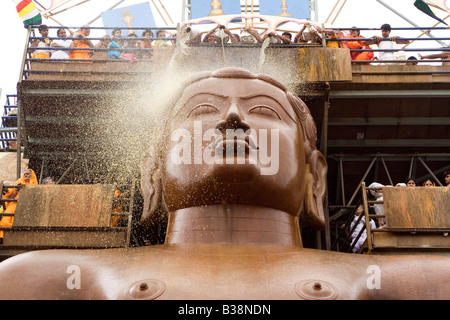 Pilgrims anoint the statue of Lord Bahubali during the Mahamastakabisheka festival in Shravanabelagola, Karnataka, India. Stock Photo