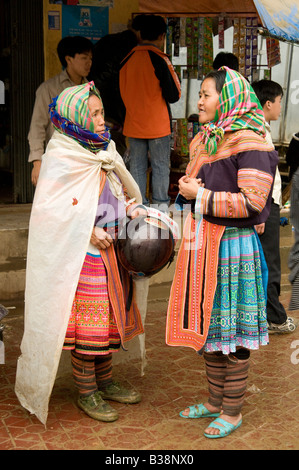 Two Hmong women wearing traditional costume talking in Muong Khuong market Vietnam Stock Photo