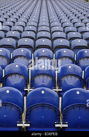 Numbered rows of empty blue seats in a sporting arena or stadium Stock Photo