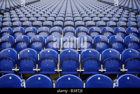 Numbered rows of empty blue seats in a sporting arena or stadium Stock Photo