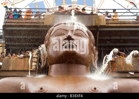 Pilgrims anoint the statue of Lord Bahubali during the Mahamastakabisheka festival in Shravanabelagola, Karnataka, India. Stock Photo