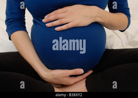 Cropped shot of a pregnant woman's stomach Stock Photo