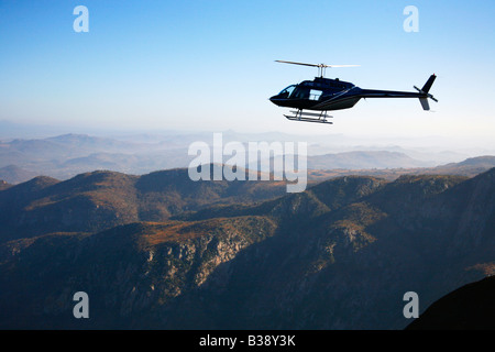 Aerial view of a helicopter flying in a scenic mountainous area Stock ...