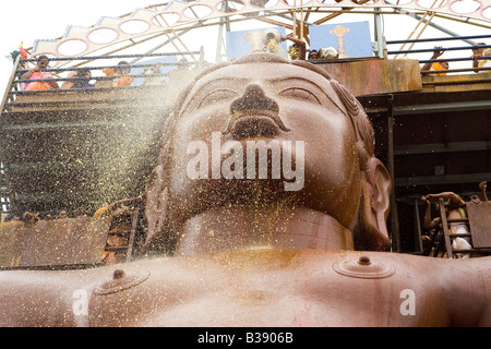 Pilgrims anoint the statue of Lord Bahubali during the Mahamastakabisheka festival in Shravanabelagola, Karnataka, India. Stock Photo