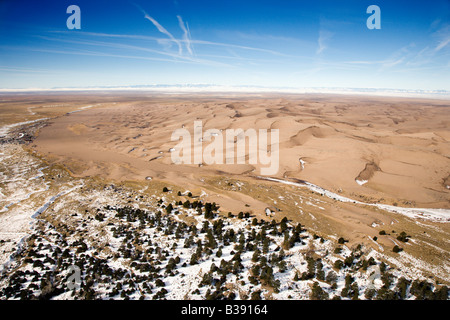 Aerial landscape of snowy plains and dunes in Great Sand Dunes National Park Colorado Stock Photo