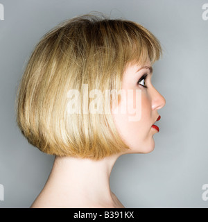 Profile portrait of young blonde caucasian woman who looks surprised Stock Photo
