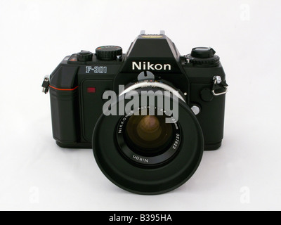 Used Nikon 301 SLR camera with Nikkor 35 mm manual focus lens and generic lens hood Stock Photo