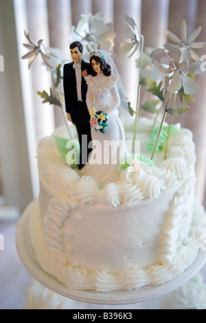 A bride and groom figurine tops a wedding cake. Stock Photo