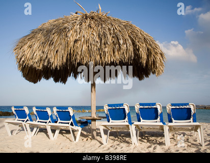 Row of deck chairs on tropical beach Piscadera Bay beach Curacao Netherlands Antilles Caribbean Stock Photo