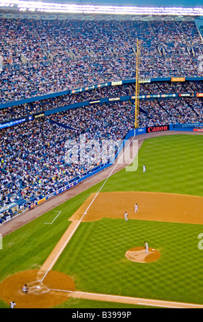 THE BRONX, New York City, United States — A baseball game is in progress at the old Yankee Stadium, with the New York Yankees facing off against the Baltimore Orioles. The iconic venue, known as 'The House That Ruth Built,' hosts a crowd of passionate fans watching America's pastime. The historic stadium, with its distinctive facade and Monument Park, provides a backdrop steeped in baseball lore as two American League East rivals compete on the diamond. Stock Photo