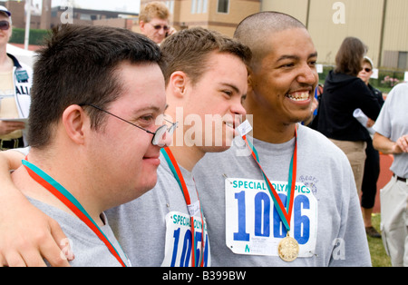 Athletes age 18 posing for picture with award medals. Special Olympics U of M Bierman Field. Minneapolis Minnesota USA Stock Photo