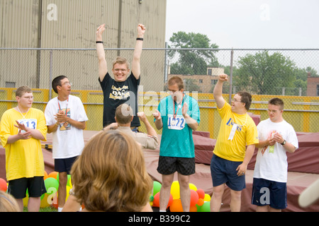 Victory for winning athlete at award ceremony. Special Olympics U of M Bierman Athletic Complex. Minneapolis Minnesota USA Stock Photo