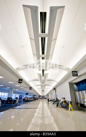 HOUSTON, Texas, United States — The interior of George Bush Intercontinental Airport (IAH) showcases a modern and bustling air travel hub. This expansive facility, one of the busiest airports in the United States, features wide concourses with high ceilings, numerous check-in counters, security checkpoints, and a variety of shops and restaurants. As a major international gateway and United Airlines hub, the airport's design reflects its role in facilitating both domestic and global air travel. Stock Photo