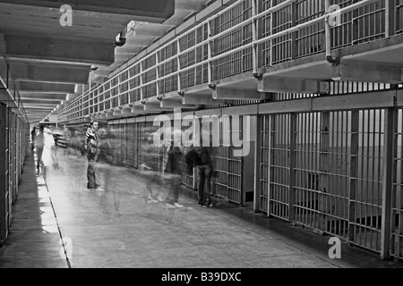 Alcatraz prison cells in black and white with ghostly looking people Stock Photo