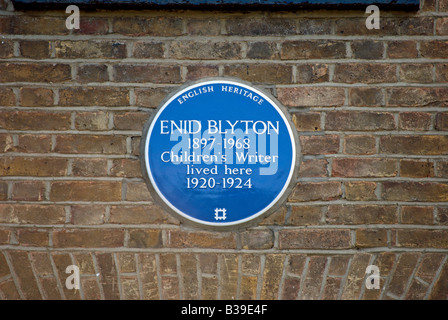 blue plaque marking a former home of enid blyton, popular author of stories for children, located in tolworth, surrey, england Stock Photo
