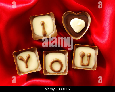 I Love You written in chocolates with red heart shaped chocolates. Stock Photo