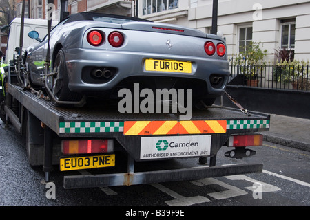 light blue car getting towed