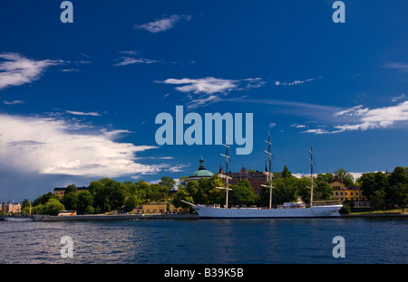 Tall sailing ship moored along seawall near downtown Stockholm, Sweden on a sunny summer mid-afternoon. Stock Photo
