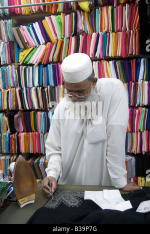 Dress maker embroidering habaya Old Souq Mutrah Muscat Oman Stock Photo
