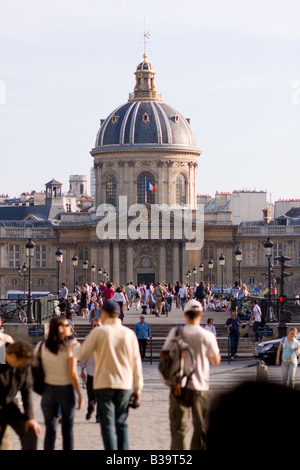 People milling around the Pont des Arts in the heart of Paris Stock Photo