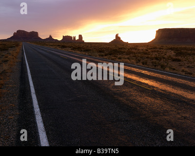 Scenic sunset landscape of highway in Monument Valley on the border of Arizona and Utah United States Stock Photo