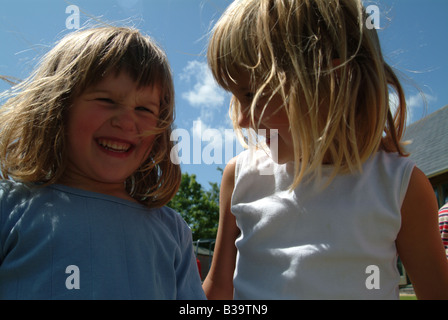 Two little girls laughing together Stock Photo