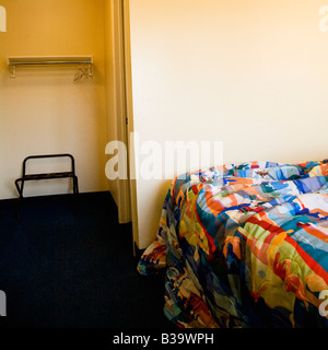 Interior shot of motel room with unmade bed and closet Stock Photo
