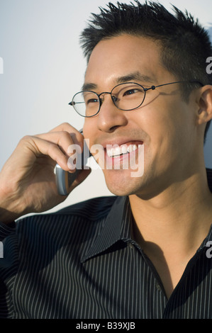 Asian man talking on cell phone Stock Photo