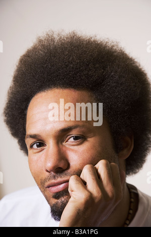 African man resting chin on hand Stock Photo