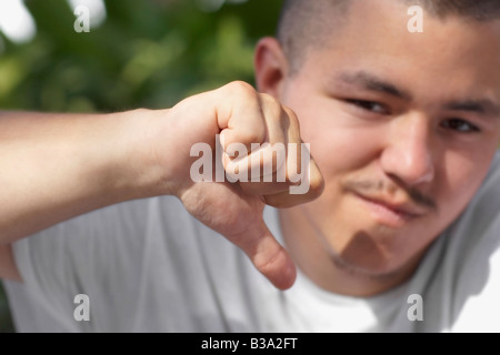 Pacific Islander man giving thumbs down Stock Photo
