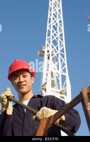Asian male construction worker wearing hardhat Stock Photo