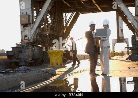 African American businesspeople wearing hardhats Stock Photo