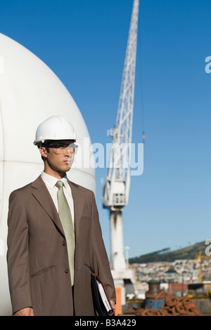 Asian businessman wearing hardhat Stock Photo