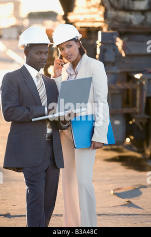 African American businesspeople wearing hardhats Stock Photo