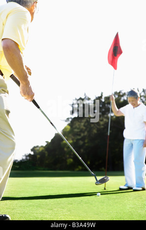 Senior Asian couple playing golf Stock Photo