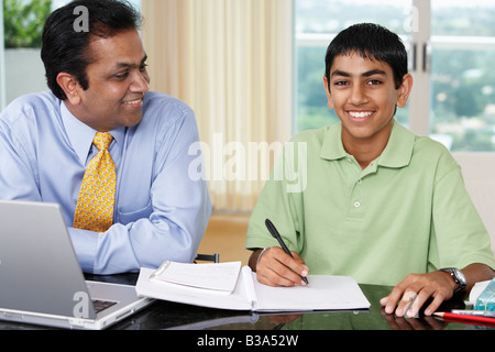 Middle Eastern father helping son with homework Stock Photo