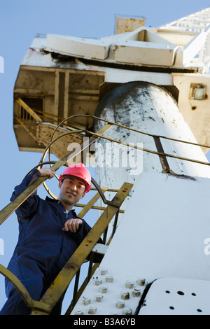 Asian male construction worker on crane Stock Photo