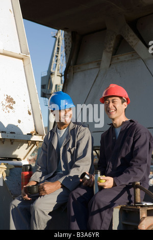 Multi-ethnic male construction workers drinking coffee Stock Photo