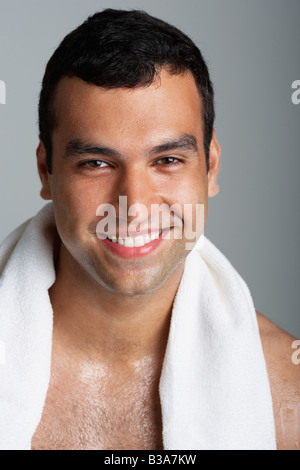 Hispanic man with towel around neck Stock Photo