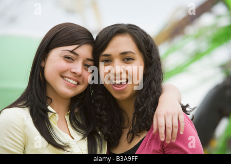 Multi-ethnic teenaged girls hugging Stock Photo