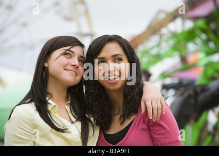 Multi-ethnic teenaged girls hugging Stock Photo