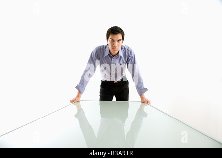 Young Asian business man standing over conference table Stock Photo
