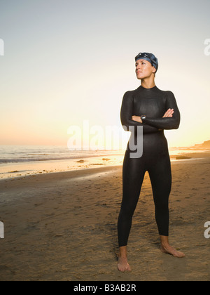 Hispanic woman wearing wetsuit and goggles